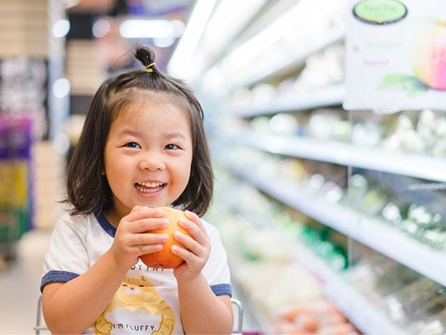 Child holding an apple